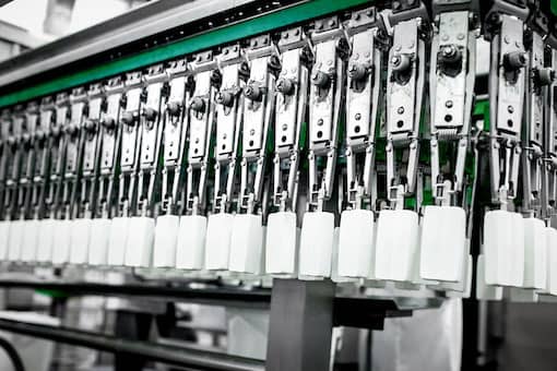 White popsicles hanging from manufacturing machinery